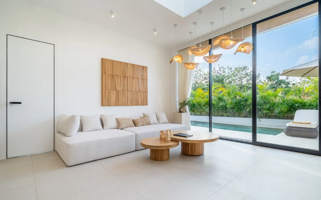 Living room of a completed Ardhana villa, opening onto its private pool